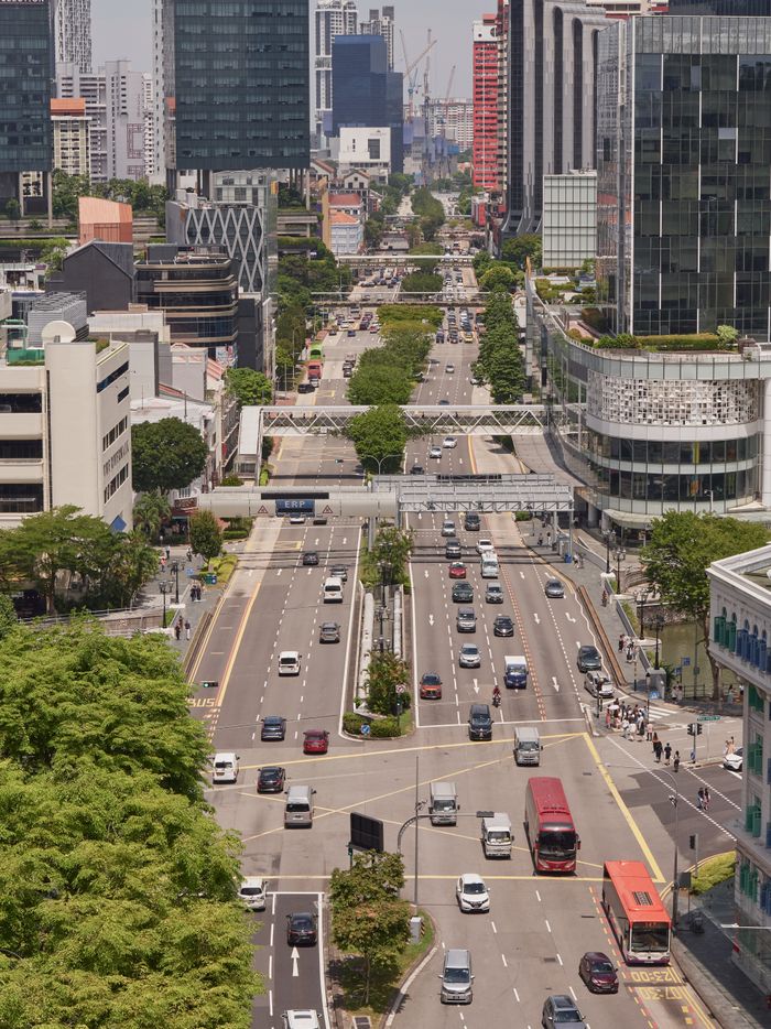 Aerial view of a vibrant city street with heavy traffic in Singapores bustling downtown area.